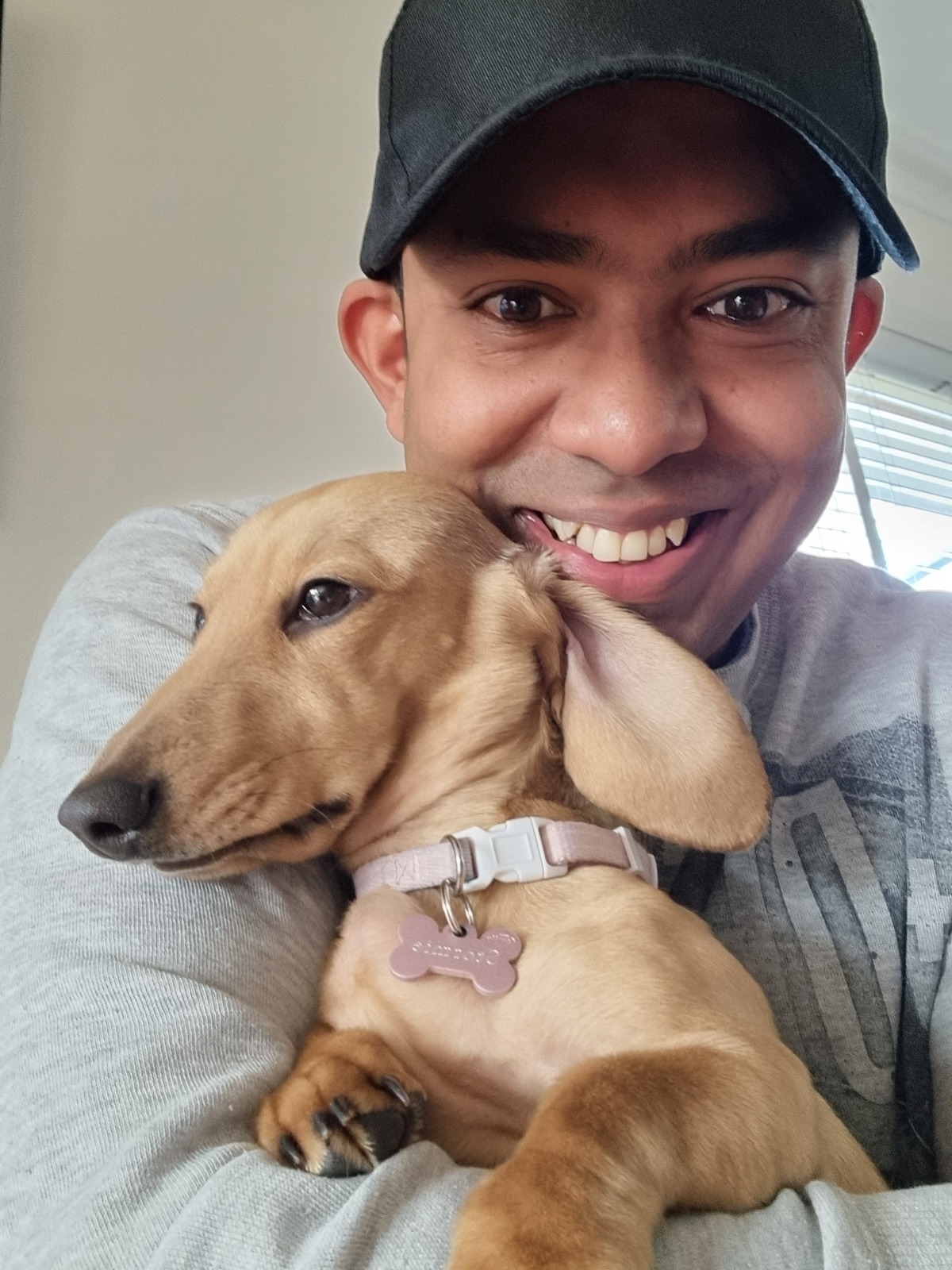 Dog's Blog 67 Reza from Pet Stays Dog Boarding Melbourne holding a clients Daschound puppy. Don’t Miss Out Book Your Dog’s Holiday Care Early